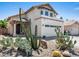 Two-story home featuring a stucco exterior, tile roof, desert landscaping, and an attached two-car garage at 18031 N 12Th Pl, Phoenix, AZ 85022