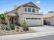 Charming two-story home featuring stucco exterior, tile roof, desert landscaping, and attached two-car garage at 18031 N 12Th Pl, Phoenix, AZ 85022