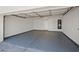 Spacious garage with epoxy flooring, featuring ample storage and parking at 18031 N 12Th Pl, Phoenix, AZ 85022