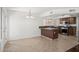 Open kitchen featuring tile floors, breakfast bar, stainless steel appliances, and brown cabinets at 18031 N 12Th Pl, Phoenix, AZ 85022