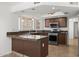 Well-lit kitchen with stainless steel appliances and granite countertops at 18031 N 12Th Pl, Phoenix, AZ 85022