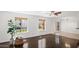 Well-lit living room showcasing hardwood floors, large windows, and a serene atmosphere at 18031 N 12Th Pl, Phoenix, AZ 85022