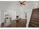Open-concept living room with fireplace, hardwood floors, staircase, and abundant natural light at 18031 N 12Th Pl, Phoenix, AZ 85022