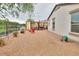 Backyard area featuring a gravel ground, an exterior elevation of the home, and red chairs at 18309 N Crestview Ln, Maricopa, AZ 85138
