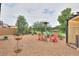 Backyard area featuring a metal fence, red chairs, and a patio heater at 18309 N Crestview Ln, Maricopa, AZ 85138