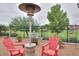 Backyard featuring a metal fence, red chairs, and a patio heater at 18309 N Crestview Ln, Maricopa, AZ 85138