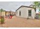 Backyard area featuring a gravel ground, an exterior elevation of the home, and red chairs at 18309 N Crestview Ln, Maricopa, AZ 85138