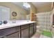 Bathroom featuring a double sink vanity, a toilet, and a shower with a patterned curtain at 18309 N Crestview Ln, Maricopa, AZ 85138