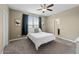 Bedroom with carpet floors, window with blinds, and a light ceiling fan at 18309 N Crestview Ln, Maricopa, AZ 85138