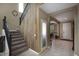Foyer with stairs, wood-accent wall, and tile flooring at 18309 N Crestview Ln, Maricopa, AZ 85138