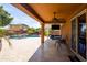 Covered back patio with ceiling fan, outdoor TV, furniture and a pool at 18649 W Williams St, Goodyear, AZ 85338
