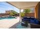 Covered back patio with view of pool and comfortable patio furniture at 18649 W Williams St, Goodyear, AZ 85338