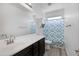 Bathroom features single sink, blue and white shower curtain and light gray flooring at 18649 W Williams St, Goodyear, AZ 85338