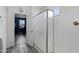 Bathroom boasts modern walk-in shower with light gray flooring and a view into a bedroom at 18649 W Williams St, Goodyear, AZ 85338