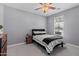 Bedroom with neutral walls, carpeted floors, a ceiling fan and a simple bed at 18649 W Williams St, Goodyear, AZ 85338