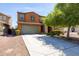 Charming two-story home with a well-manicured front yard and a two-car garage at 18649 W Williams St, Goodyear, AZ 85338
