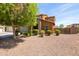 Beautiful two-story home with stone accents, a well-maintained lawn, and mature trees at 18649 W Williams St, Goodyear, AZ 85338