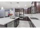 Modern kitchen with stainless steel appliances, white countertops, and dark cabinetry at 18649 W Williams St, Goodyear, AZ 85338