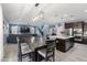 Open-concept living space with kitchen island, dining area, and comfortable seating area at 18649 W Williams St, Goodyear, AZ 85338