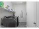 Functional laundry room features gray flooring, shelving for storage, and included washer and dryer at 18649 W Williams St, Goodyear, AZ 85338