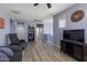 Upstairs bonus living room with entertainment center and relaxing chair, neutral walls and wood floors at 18649 W Williams St, Goodyear, AZ 85338
