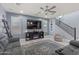 Inviting living room featuring a cozy armchair, a decorative ladder shelf, and a large television at 18649 W Williams St, Goodyear, AZ 85338