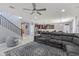 Open-concept living room with a staircase, a comfortable sectional sofa, and an adjacent kitchen at 18649 W Williams St, Goodyear, AZ 85338