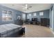 Spacious main bedroom with blue walls, wood floors, and lots of natural light at 18649 W Williams St, Goodyear, AZ 85338