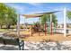 Community playground with playground equipment, benches, and walking paths at 18649 W Williams St, Goodyear, AZ 85338