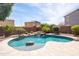 Inviting backyard pool featuring stone accents and a sun-shelf, perfect for relaxation and enjoyment at 18649 W Williams St, Goodyear, AZ 85338