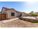Backyard with a covered patio, grill, fire pit, a paved sitting area, and low-maintenance desert landscaping at 19342 W Morning Glory Dr, Buckeye, AZ 85326