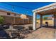 Spacious backyard with brick pavers, an outdoor table, string lights, grill and a fire pit at 19342 W Morning Glory Dr, Buckeye, AZ 85326