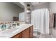 Well-lit bathroom featuring a single sink vanity, tile backsplash, and a bathtub with a shower at 19342 W Morning Glory Dr, Buckeye, AZ 85326