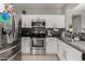 Galley kitchen with stainless steel appliances, and tiled backsplash at 19342 W Morning Glory Dr, Buckeye, AZ 85326