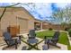 Relaxing backyard patio area with artificial grass, desert landscaping, and stylish Adirondack chairs at 1951 W Plum Rd, Phoenix, AZ 85085
