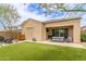 Backyard features artificial turf, covered patio with fan, and lush landscaping at 1951 W Plum Rd, Phoenix, AZ 85085