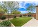 Low-maintenance backyard with artificial turf, paver patio, and desert landscaping; perfect for outdoor living at 1951 W Plum Rd, Phoenix, AZ 85085