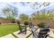 Inviting backyard seating area with artificial grass and desert landscaping at 1951 W Plum Rd, Phoenix, AZ 85085