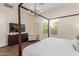 Well-lit bedroom featuring a window with plantation shutters and a modern bed frame at 1951 W Plum Rd, Phoenix, AZ 85085