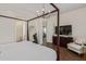Bedroom boasts a stylish mirror, a large television, and a modern four-poster bed at 1951 W Plum Rd, Phoenix, AZ 85085