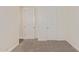 Bedroom features neutral carpet, white trim, and multiple doorways and closet at 1951 W Plum Rd, Phoenix, AZ 85085