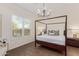 Bright bedroom featuring a four-poster bed and window with plantation shutters at 1951 W Plum Rd, Phoenix, AZ 85085