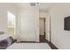 Cozy bedroom showcasing a double door closet and large windows with plantation shutters at 1951 W Plum Rd, Phoenix, AZ 85085