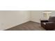 Bedroom features neutral carpet, white trim, and a comfortable leather chair near a shuttered window at 1951 W Plum Rd, Phoenix, AZ 85085