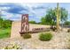 Stylish community center sign surrounded by desert landscaping and mature trees at 1951 W Plum Rd, Phoenix, AZ 85085