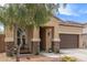 Charming single-Gathering home featuring desert landscaping, a two-car garage, and inviting covered entryway at 1951 W Plum Rd, Phoenix, AZ 85085