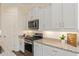 Well-lit kitchen featuring stainless steel appliances and white cabinets with stylish hardware at 1951 W Plum Rd, Phoenix, AZ 85085
