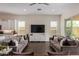 Open-concept living room featuring tile floors, comfortable sofas, and lots of natural light at 1951 W Plum Rd, Phoenix, AZ 85085