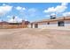 Spacious backyard with patio door, offering a blank canvas for landscaping at 2022 N 61St Ave, Phoenix, AZ 85035