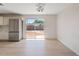 Bright dining area with wood floors, a modern light fixture, and a sliding glass door to the backyard at 2022 N 61St Ave, Phoenix, AZ 85035